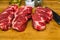 Three Chuck Steaks on Cutting Board
