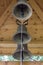 Three Church bells close-up under a wooden roof