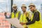 Three civil engineer standing together raise fist up to show teamwork and confident