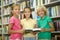 Three classmates posing for the camera at a public library