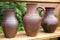 Three clay jars without frosting on the table at the fair of masters