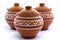 Three clay pots on a white background