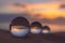 Three clear crystal balls of three sizes are sphere reveals  seascape view with spherical.  placed on the sand at Karon Beach duri