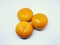 Three clementines on a white isolated background