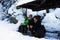 Three climbers resting on a bench in Retezat mountains, Romania