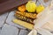 Three cobs of ornamental corn and gourds on a doorstep