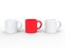 Three coffee mugs, two white and red in the middle