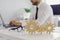 Three cogwheels joined together placed on desk against blurred background of busy office room