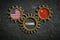 Three cogwheels on slate background with the flags of USA and the China and the word `free trade` in German