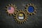 Three cogwheels on slate background with the flags of USA and the EU and the words `free trade` in the middle