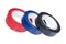 Three coils of multicolored adhesive tape
