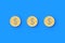 Three coins with dollar symbol on blue background. Financial indicators