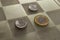 Three coins placed at a chess board creating a strategic concept for the brazilian national currency Real