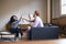 Three colleagues high five at a casual work meeting