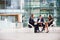 Three colleagues at a meeting in the foyer of a big business