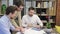 Three colleagues talking with tablet sitting in modern office indoors.