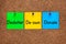 Three colored notes on corkboard with words Declutter, De-own, Donate