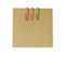 Three colored paper clips with blank notepaper. Sheet for your message or adding more text. Memo note with paper clips