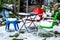 Three Colored Patio Chairs Sitting Empty In The Snow