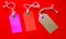 Three colored tags on a white rope, red background