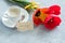 Three colored tulips on a gray concrete table. Cup of coffee Atmospheric mood