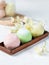 Three colorful balls of mochi or homemade ice cream. Close-up on a light background.