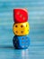 Three colorful board game dice stack. Multi colored dice laying on top of each other. Kids early school education symbol, simple