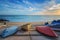 Three colorful boats resting on the shore.