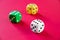 Three colorful dices isolated on pink