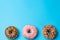 Three colorful Donuts, blue background