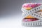 Three colorful donuts wrapped in a tailors measuring tape