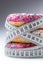 Three colorful donuts wrapped in a tailors measuring tape