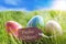 Three Colorful Easter Eggs On Sunny Green Grass With Label With German Frohe Ostern Means Happy Easter