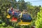 Three colorful gondolas cable cars as they transport people up and down in the Caracol Park