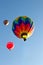 Three colorful hot air balloons ascending into sky