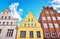 Three colorful old gabled house facades in the old town of Wismar