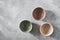 Three colorful porcelain bowls isolated on stone gray background, flat lay