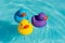 Three colorful rubber ducks, yellow, blue and purple