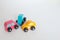 Three colorful toy cars involved in a car crash.