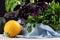 Three colorful zucchinis and basil on a black background. Organic vegetables for healthy salads on a blue tablecloth.