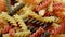 Three Colors Pasta made from durum wheat. Pasta fusilli tricolor background. Abstract texture of colorful pasta. pattern of