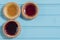 Three colourful jam tarts on a blue background