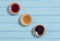 Three colourful jam tarts on a blue background