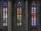Three colourful stained-glass windows in church