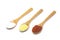 Three common spices in wooden spoons isolated on white background