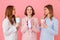 Three content women with good mood in colorful striped pyjamas s