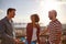 Three cool friends laughing on a bridge