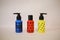 Three cosmetic bottles on a light background