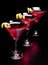 Three cosmopolitan drinks in line on black counter