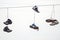 Three couples old sneakers on wires